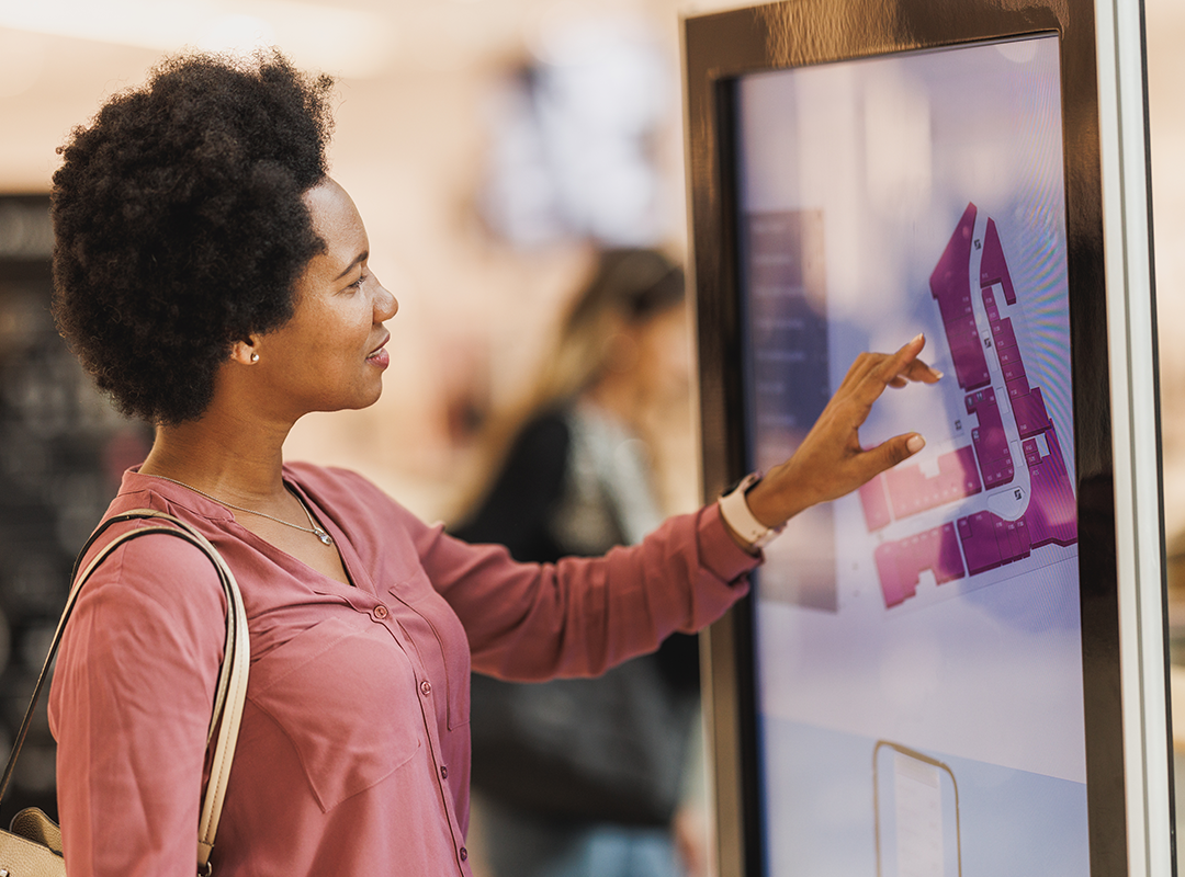 Woman Looking At Map On LED Screen