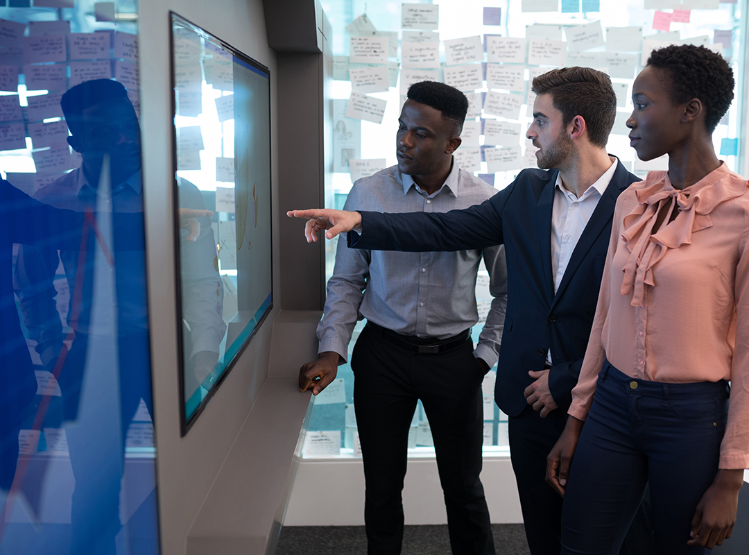 Business People Point at LED Screen